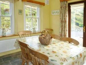 a dining room with a table with a basket on it at Hollyglen House in Common Bridge