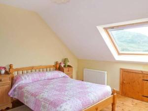 a bedroom with a bed and a large window at Hollyglen House in Common Bridge +5 photos