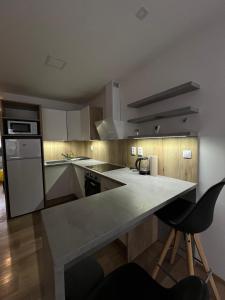 a kitchen with a large island in the middle at Apartmany CityCentrum Trencin in Trenčín