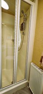 a shower with a glass door in a bathroom at Caravan in Clacton-on-Sea in Little Clacton +16 photos