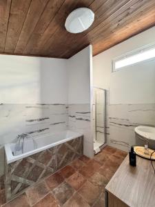 a large bathroom with a tub and a sink at Hotel Urban By Giulia in Pozzolo Formigaro