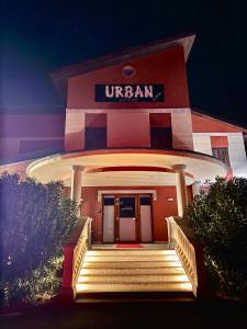 aufrian building with stairs in front of it at night at Hotel Urban By Giulia in Pozzolo Formigaro