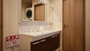 a bathroom with a sink and a mirror at Cloud House Sapporo in Sapporo +35 photos
