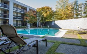 a swimming pool with a chair next to a building at Hotel 116, A Coast Hotel Bellevue in Bellevue