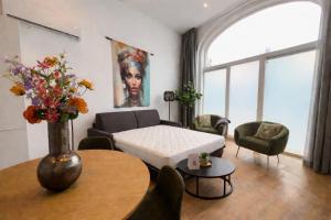 a living room with a couch and a table at Unique home near Tilburg center, uni & Efteling, in Tilburg