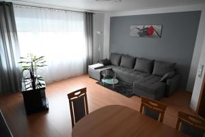 a living room with a couch and a table at Ferienwohnung Lindlar in Lindlar