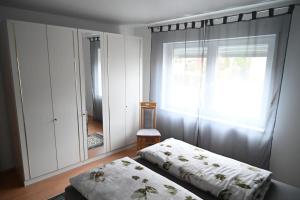 a bedroom with a bed and a large window at Ferienwohnung Lindlar in Lindlar