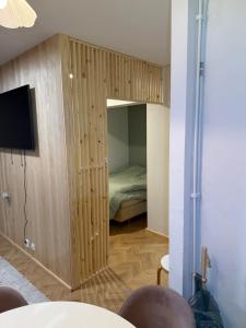a bedroom with a bed inside of a wooden cabinet at Central Kauppakatu Apartment in Joensuu