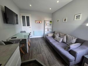 a living room with a couch and a table at 159 Smart Apartments in Newark-on-Trent