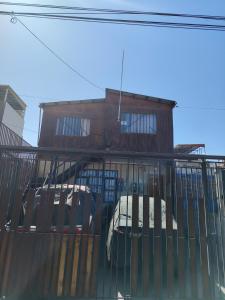 a house with cars parked in front of it at Casa de alojados in Antofagasta