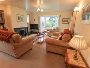 a living room with two couches and a tv at Thrang View in Ambleside