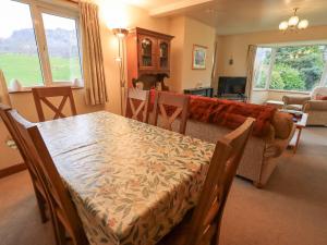 a living room with a table and a couch at Thrang View in Ambleside