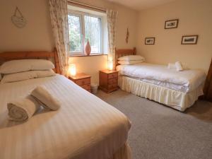 a bedroom with two beds and a window at Thrang View in Ambleside