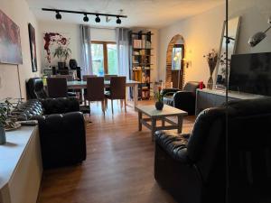 a living room with couches and a dining room at Perk25A in Steenokkerzeel