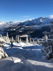 a person standing on top of a snow covered mountain at Independent studio in a chalet in Mont-Saxonnex +1 photo