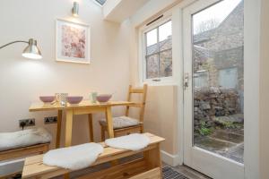 a room with a table and chairs and a window at Mill Workers Cottage in Cromford