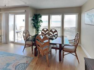 a dining room with a table and chairs at Surfside Six E Unit 5 in St. Augustine