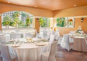 a banquet hall with white tables and white chairs at Floridays Orlando Two & Three Bed Rooms Condo Resort in Orlando