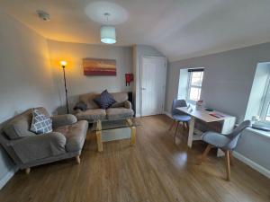 a living room with a couch and a table at 4a Smart Apartments in Newark-on-Trent
