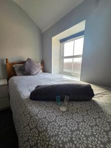 a bedroom with a bed with a large window at 4a Smart Apartments in Newark-on-Trent
