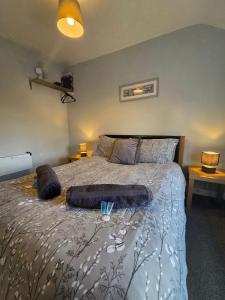 a bedroom with a large bed with two pillows at 4a Smart Apartments in Newark-on-Trent