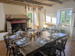 ein Esszimmer mit Tisch und Kamin in der Unterkunft Saisonnée - Chambres d'Hôtes et Table d'Hôtes en Aveyron in Centrès + 58 Fotos