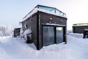 a building covered in snow with snow around it at Aurora Paradise Levi Iglu in Levi