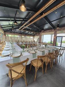 a large room with a long white table and chairs at Błażejewko Resort in Błażejewko