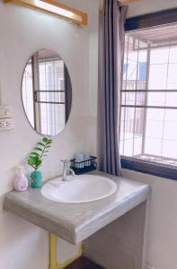 a bathroom with a sink and a mirror at Wayside Guesthouse in Chiang Mai +130 photos