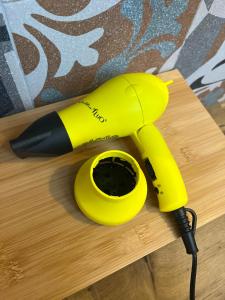 a yellow telephone sitting on a wooden table at Stanza in sondrio Coel in Sondrio