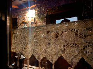 a table with a lace curtain in front of a window at Feel-Harmonia w Nowym Kawkowie in Nowe Kawkowo +41 photos