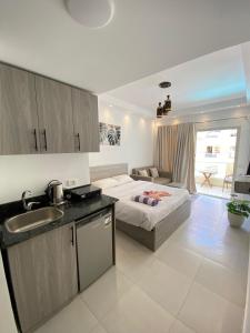a bedroom with a bed and a kitchen with a sink at florenza Resort - Hurghada Egypt in Hurghada