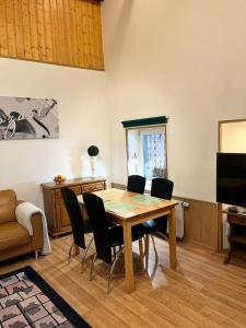 a dining room with a wooden table and chairs at Bella Patria in Rozwadza