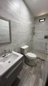 a bathroom with a toilet and a sink at Casa Completa in Rancho San Pedro