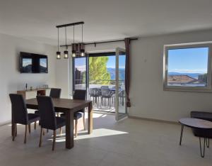 a dining room and living room with a table and chairs at Natalija Adriatic 2 in Krk