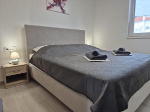 a bedroom with a bed with two towels on it at Natalija Adriatic 2 in Krk +28 photos