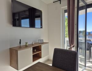 a living room with a table and a mirror on the wall at Natalija Adriatic 2 in Krk