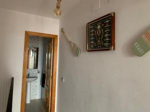 a bathroom with a sink and a picture on the wall at Casa Pera Ático duplex 1ª in Chilches +12 photos