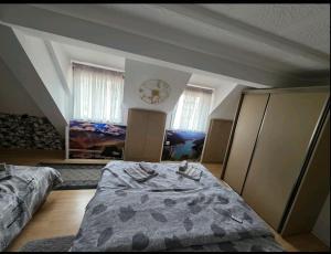 a bedroom with two beds and two windows at Apartment Đina in Plužine