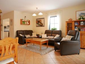 a living room with couches and a coffee table at Hagebutte in Am Schwarzen Busch