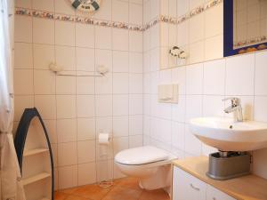 a bathroom with a toilet and a sink at Hagebutte in Am Schwarzen Busch +11 photos