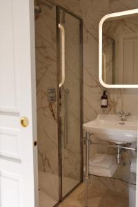 a bathroom with a shower and a sink at Logis Hôtel Maison Turenne in Martel +53 photos