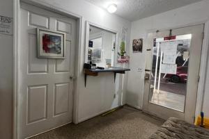 a room with a white door and a window at Cross City Motel by Hotel O US 19 in Cross City +16 photos