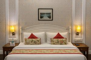 a bedroom with a large bed with red pillows at Hotel Bright in New Delhi +31 photos