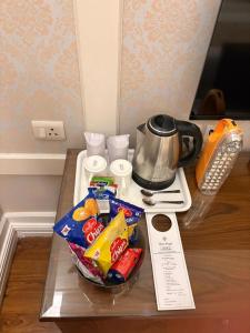 a counter top with chips and snacks on a table at Hotel Bright in New Delhi