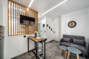 a living room with a couch and a table at Eirini & Nicol Studios by Cretanhouses in Thérissos +25 photos