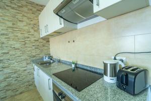 a kitchen with a sink and a toaster on a counter at Edificio Prieto VIV 2A in Puerto del Rosario