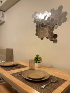 a table with plates and utensils on top at ARC Hive Staycation in Suba