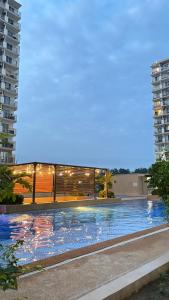 a large swimming pool in front of a building at ARC Hive Staycation in Suba