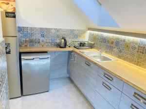 a small kitchen with a sink and a dishwasher at M&M Marzeniowo in Chlebowo +9 photos